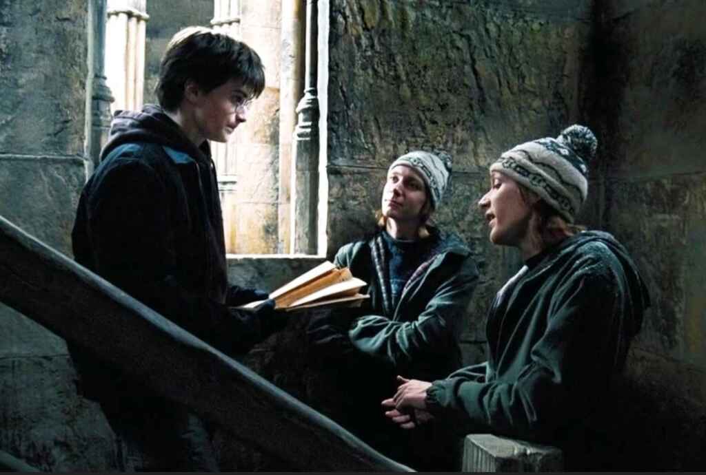 Harry holding the Marauder's Map with the twins