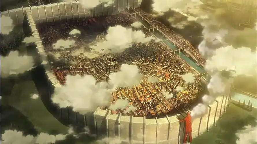 A giant Titan peers over the outer wall in Attack on Titan.