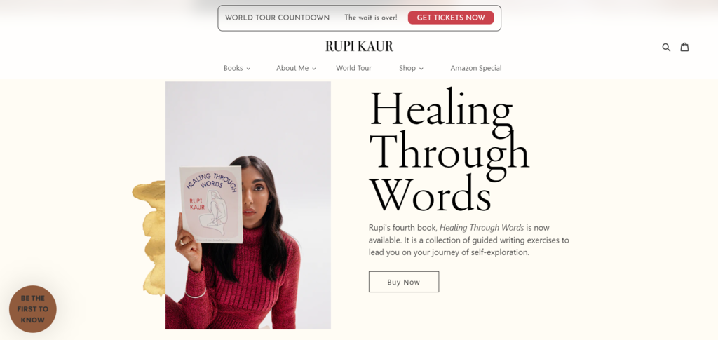 Rupi Kaur holds up her latest book under the headline 