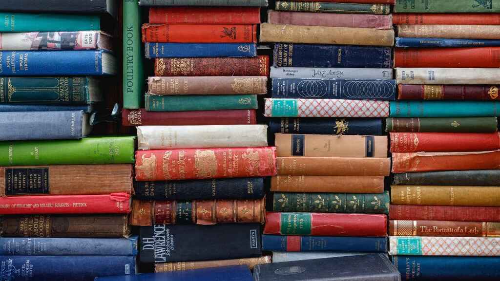 Stacks of multicolored hardcover books.