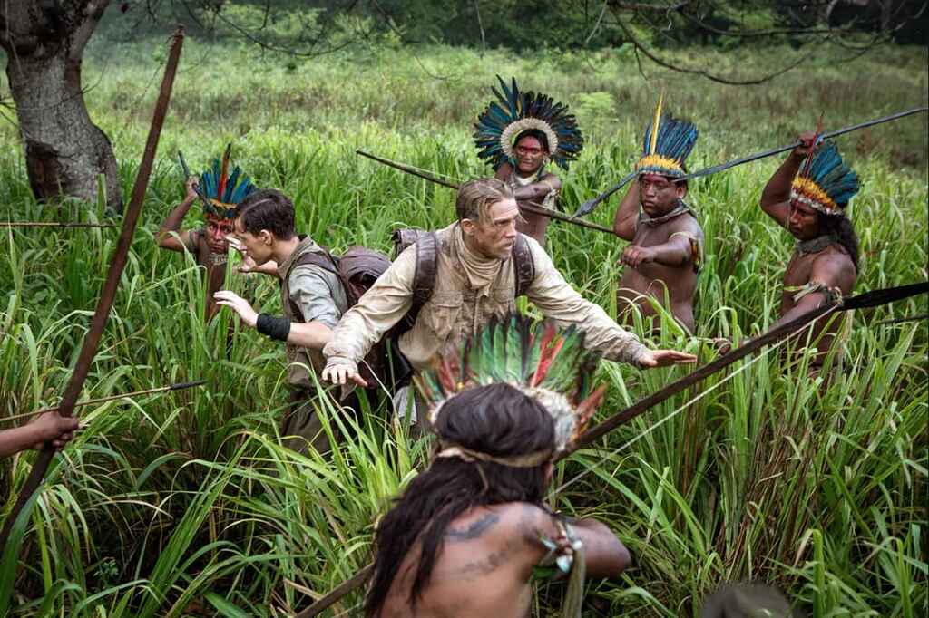 Still from the movie The Lost City of Z in which the explorer is surrounded by an Amazon native tribe