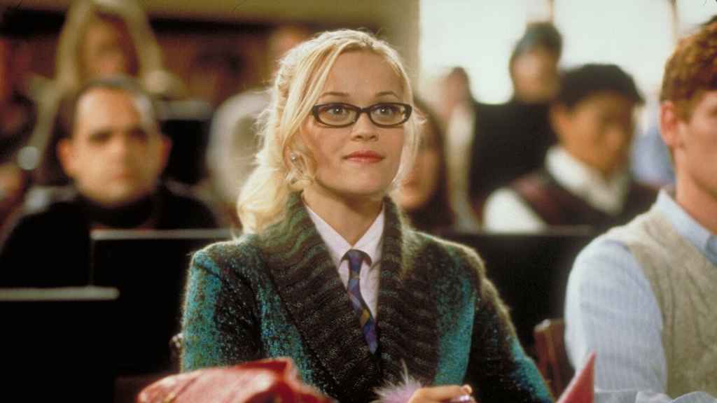 Conflict | Elle sits in class in a green jacket. From the film Legally Blonde