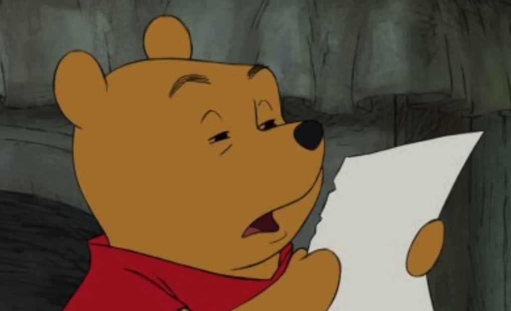 copy editing vs proofreading Winnie the Pooh squinting to read a paper.