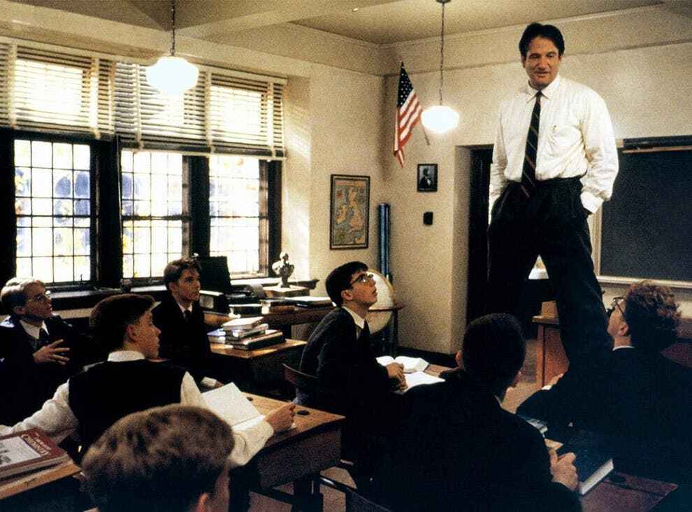 How to Publish a Poetry Book | Scene from the movie Dead Poets Society, showing the teacher standing on a desk among sitting students.