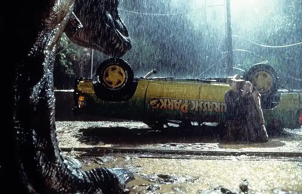 Alan and Lex remain still to avoid teh gaze of a T-Rex in Jurassic Park