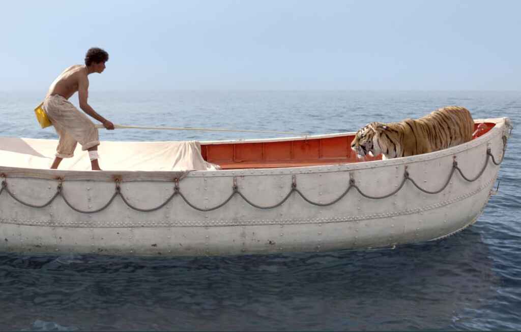 A sill image from the movie Life of Pi with Pi and the tiger on the boat