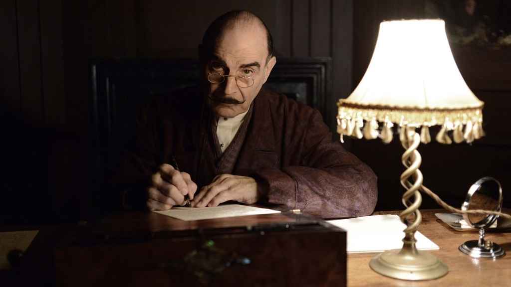 copy editing vs proofreading | David Suchet as Poirot, examining a document