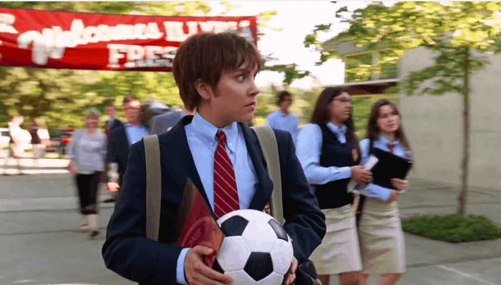 Amanda Bynes, dressed as her own brother, clutching a soccer ball